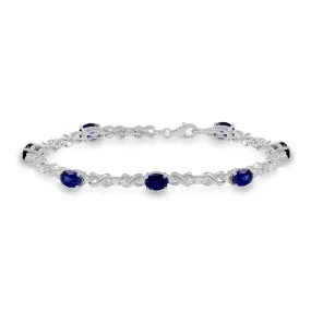 Jewelili Sterling Silver 7x5 mm Oval Shape Created Blue Sapphire and Created White Sapphire Bracelet