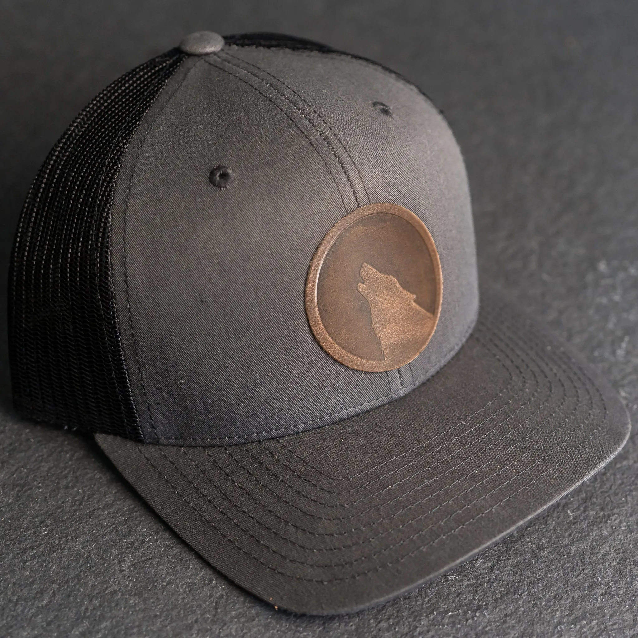 Leather Patch Trucker Style Hat - Wolf Stamp