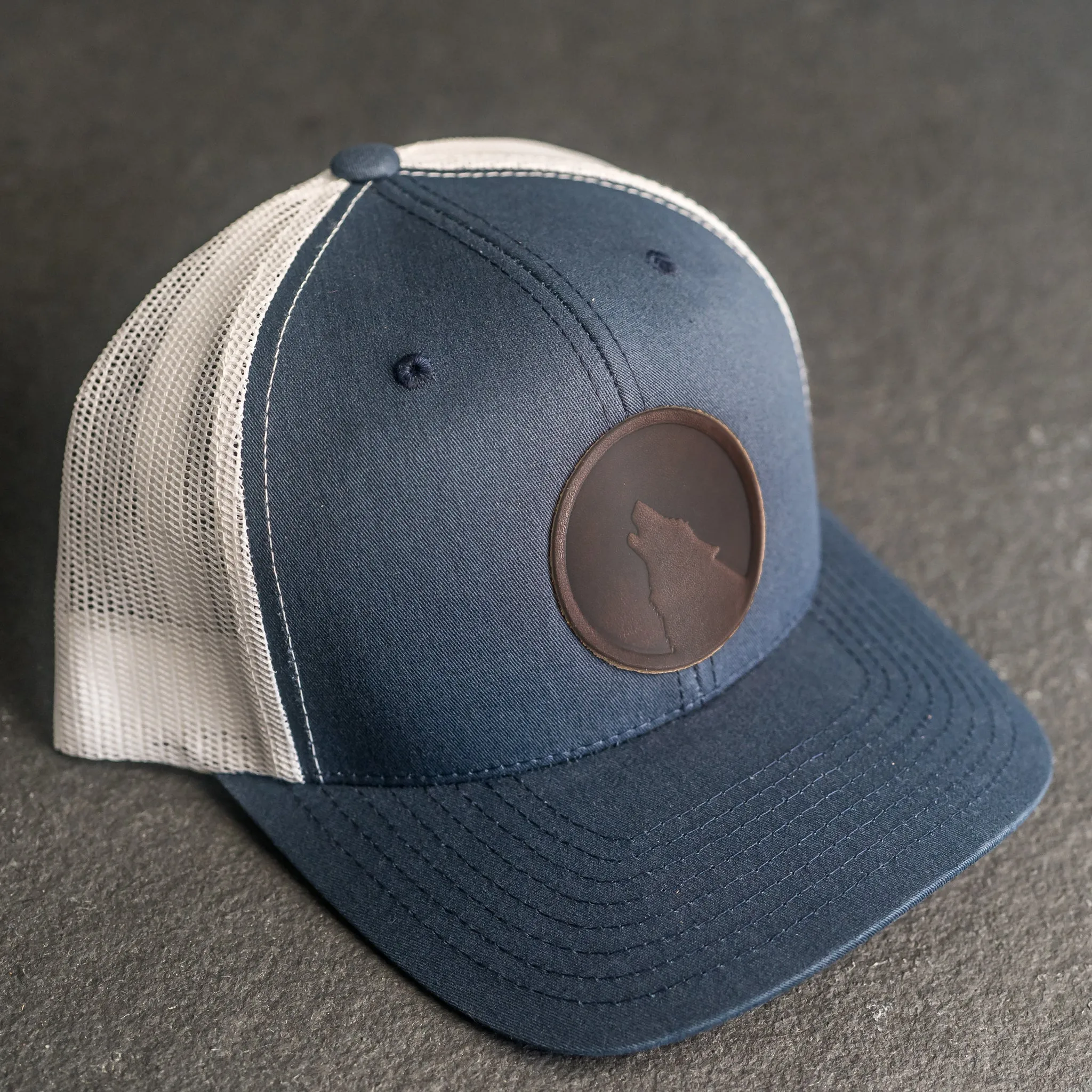 Leather Patch Trucker Style Hat - Wolf Stamp